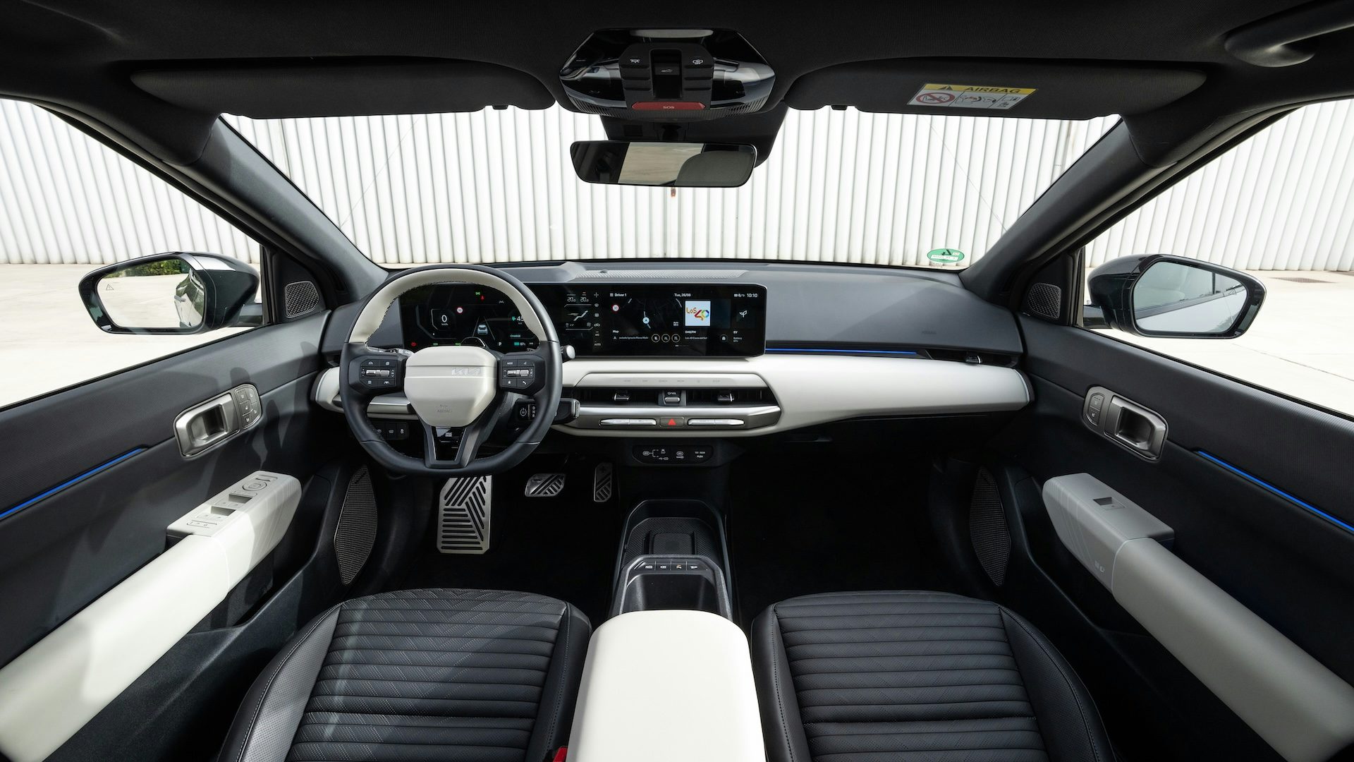 2025 Kia EV4 Fastback interior with black and white upholstery.